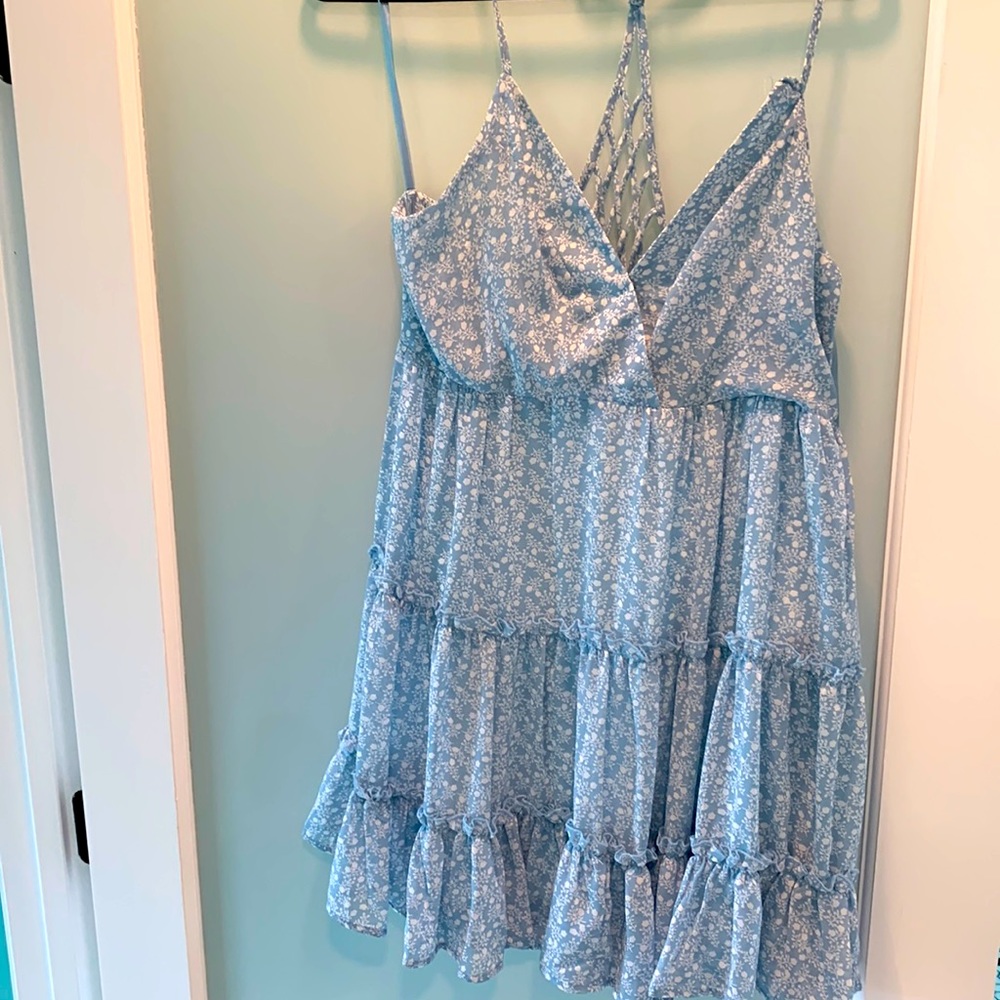 Near in Sleeveless fit flare dress tiered ruffle skirt and lattice back.